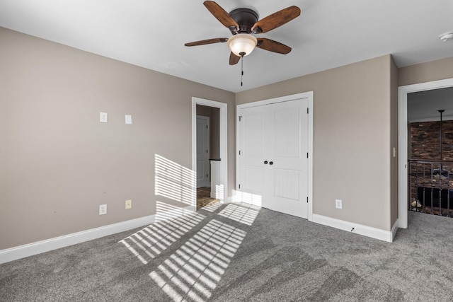 unfurnished bedroom with a ceiling fan, baseboards, carpet, and a closet