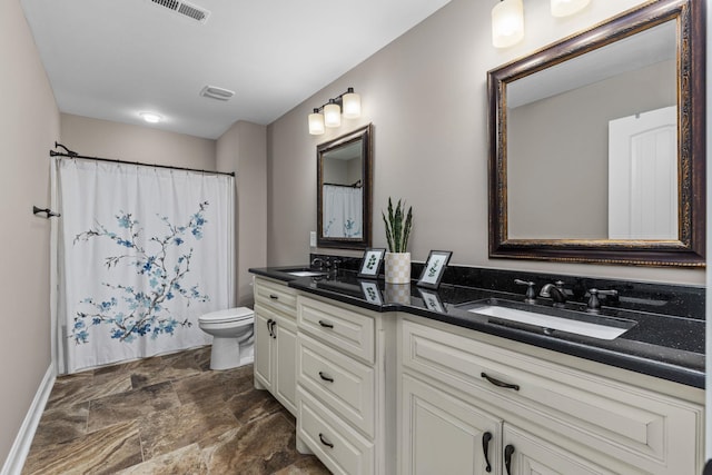 full bath with a sink, stone finish floor, double vanity, and visible vents
