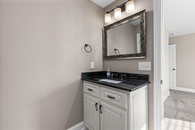 bathroom with baseboards and vanity