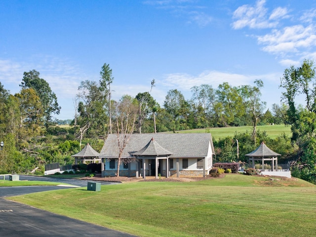 view of front of property featuring a gazebo and a front lawn