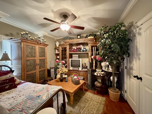 bedroom with ceiling fan, crown molding, and dark hardwood / wood-style floors