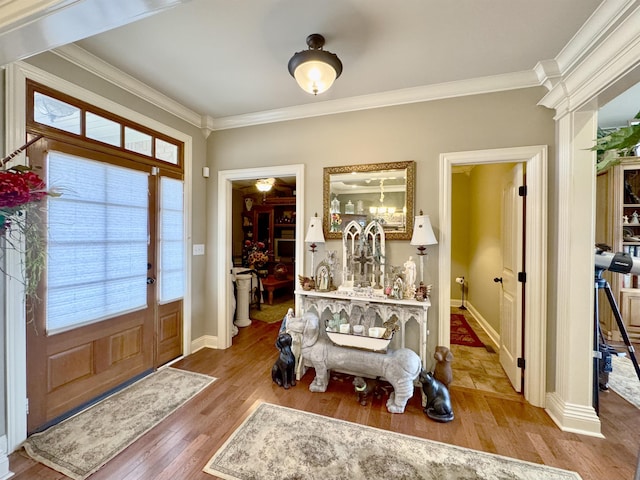 entrance foyer featuring a wealth of natural light, crown molding, and wood-type flooring