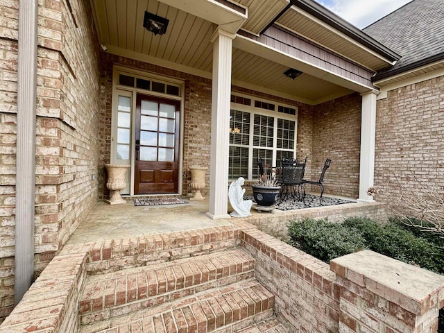 view of exterior entry featuring covered porch