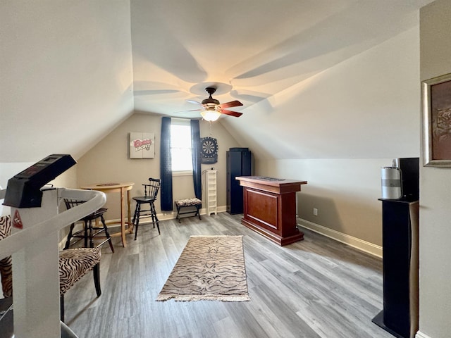 office area with light hardwood / wood-style flooring, ceiling fan, and lofted ceiling