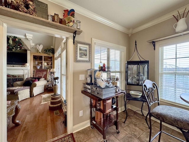 home office with tile patterned flooring, a healthy amount of sunlight, ornamental molding, and a fireplace