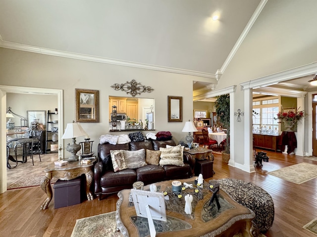 living room featuring ornate columns, crown molding, high vaulted ceiling, and hardwood / wood-style flooring