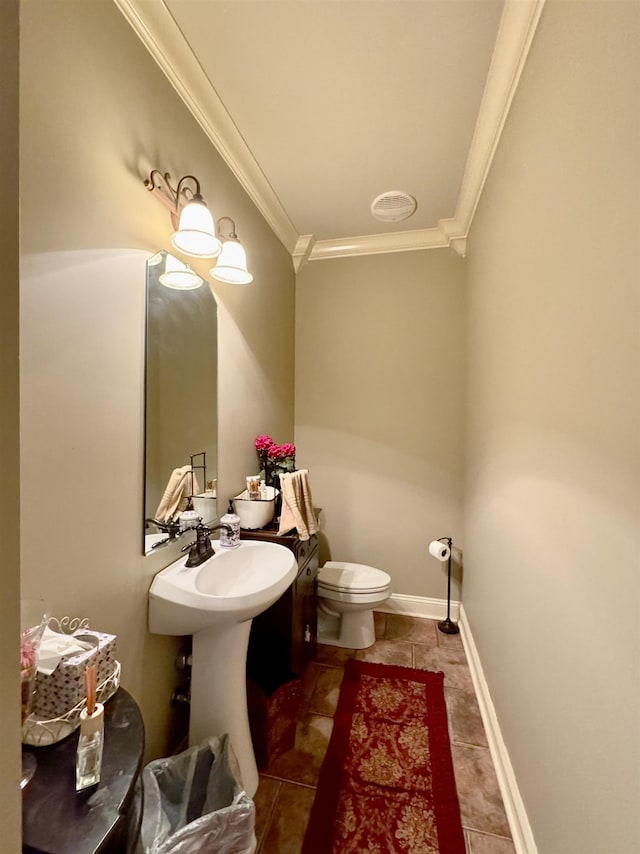 bathroom featuring tile patterned floors, toilet, and ornamental molding