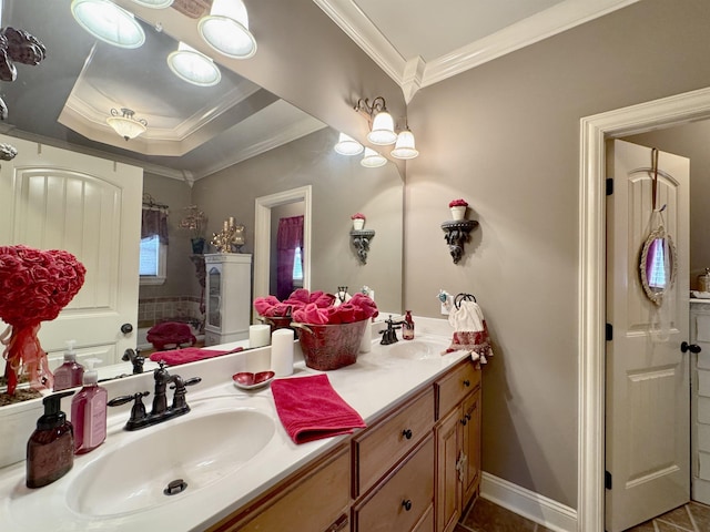 bathroom with vanity, a raised ceiling, and ornamental molding