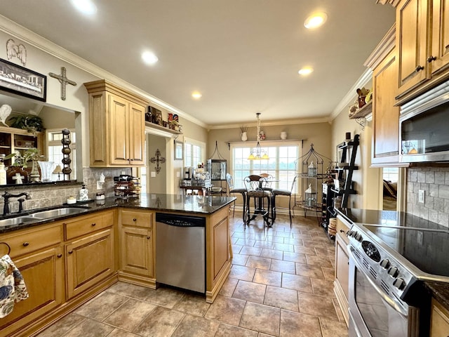 kitchen with kitchen peninsula, appliances with stainless steel finishes, tasteful backsplash, sink, and hanging light fixtures