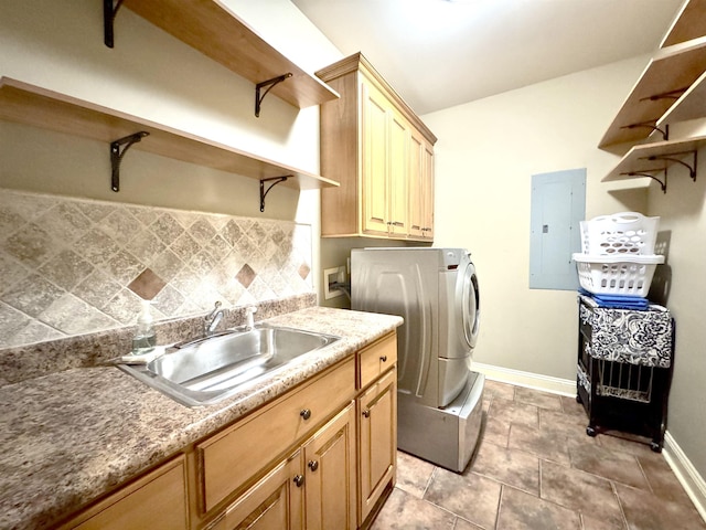 clothes washing area with electric panel, washer / clothes dryer, sink, and cabinets