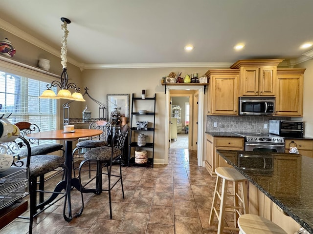 kitchen featuring backsplash, stainless steel appliances, crown molding, pendant lighting, and dark tile patterned flooring