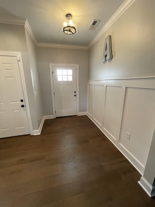 entryway featuring ornamental molding and dark hardwood / wood-style floors