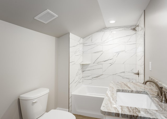 bathroom featuring visible vents, washtub / shower combination, toilet, and vanity