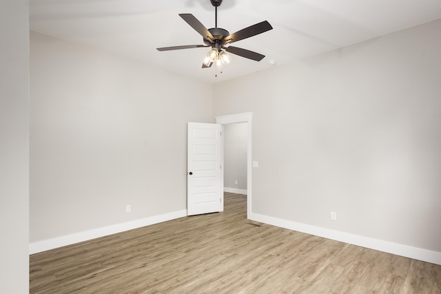 empty room featuring baseboards, ceiling fan, and wood finished floors
