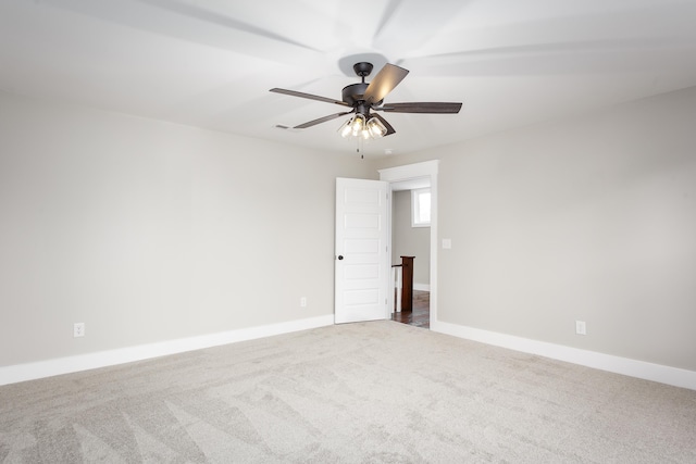 unfurnished room featuring baseboards, a ceiling fan, and carpet