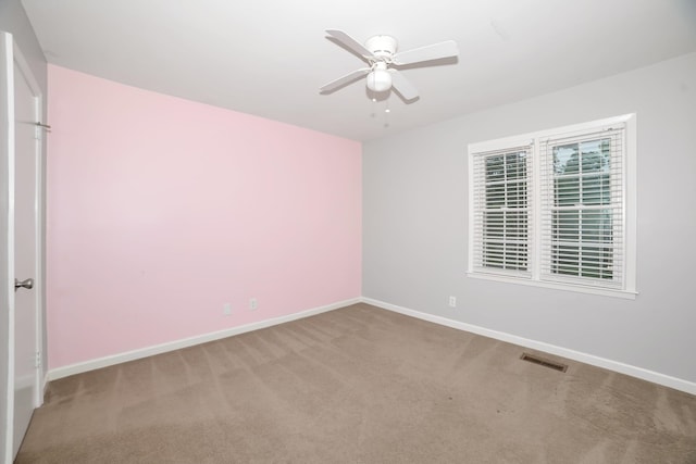  - empty room with ceiling fan, baseboards, and carpet flooring