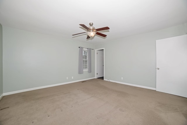  - carpeted spare room with ceiling fan and baseboards