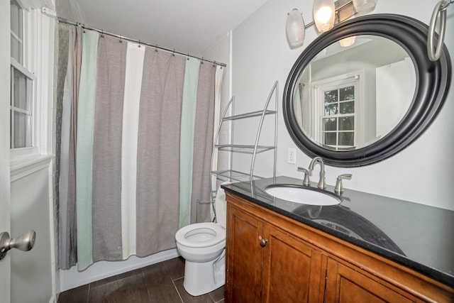 - full bathroom with vanity, toilet, wood finished floors, and shower / bath combo with shower curtain