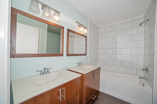  - bathroom featuring two vanities and shower / tub combination