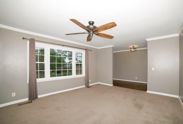  - empty room with crown molding, baseboards, a ceiling fan, and carpet