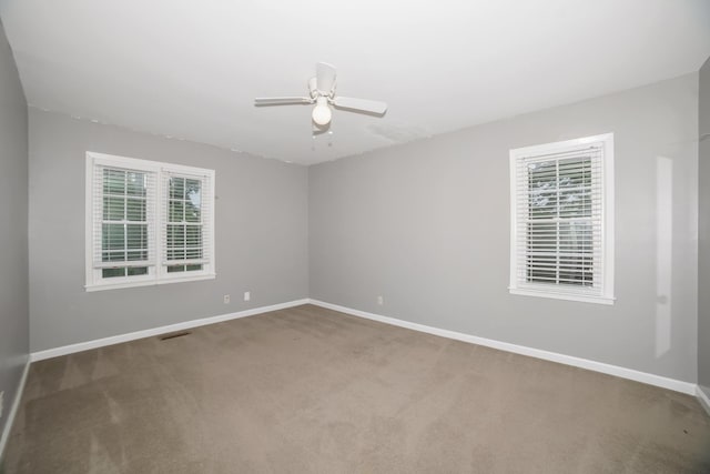  - carpeted spare room featuring baseboards and a ceiling fan