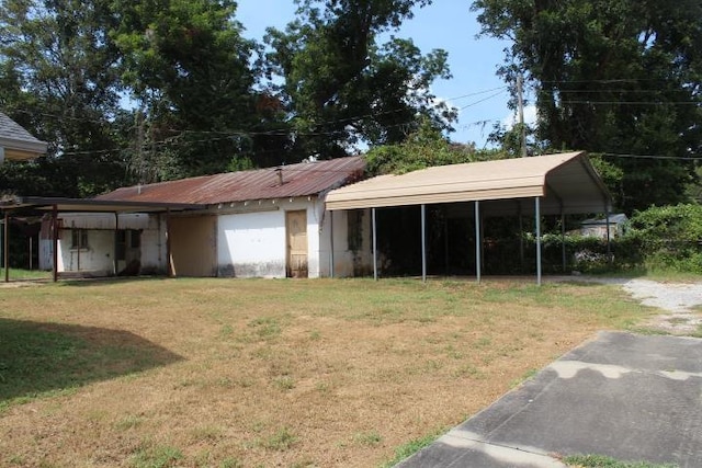 exterior space featuring a carport and a yard