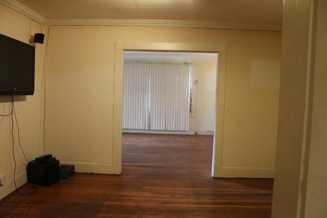 spare room with dark hardwood / wood-style flooring and crown molding