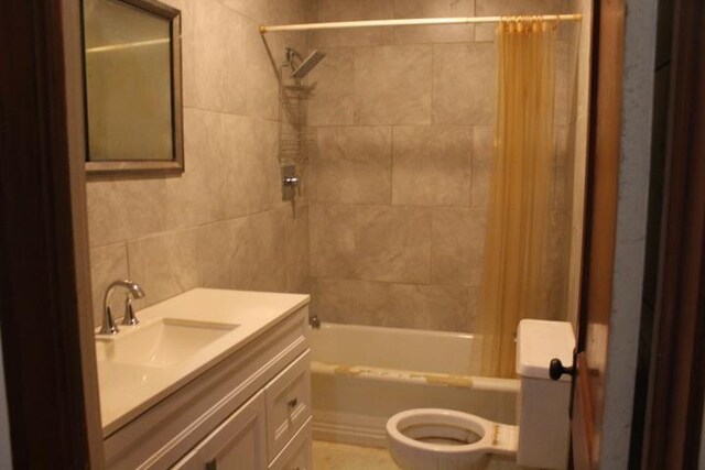 full bathroom featuring vanity, toilet, and shower / bathtub combination with curtain