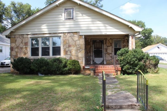 bungalow-style home with a front lawn