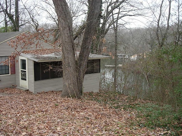 view of property exterior featuring a sunroom