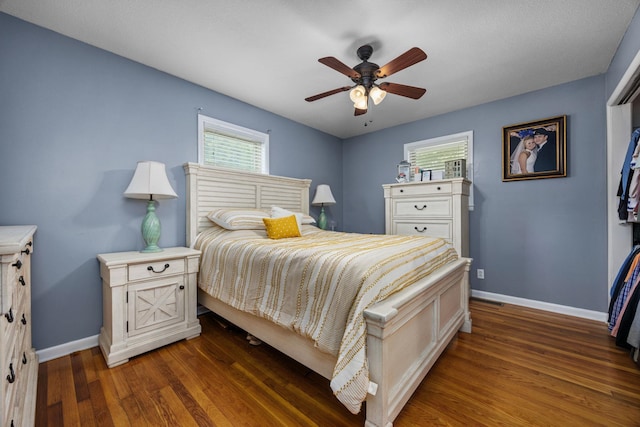 bedroom featuring dark hardwood / wood-style flooring and ceiling fan