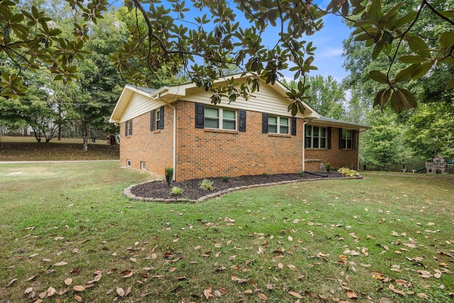 view of side of property with a yard