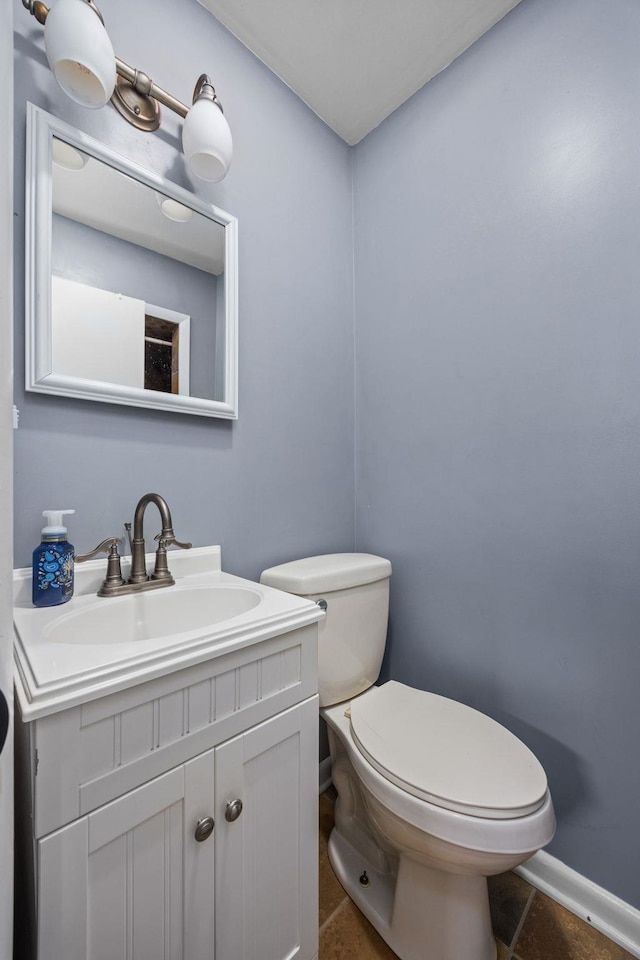 bathroom with tile patterned flooring, vanity, and toilet