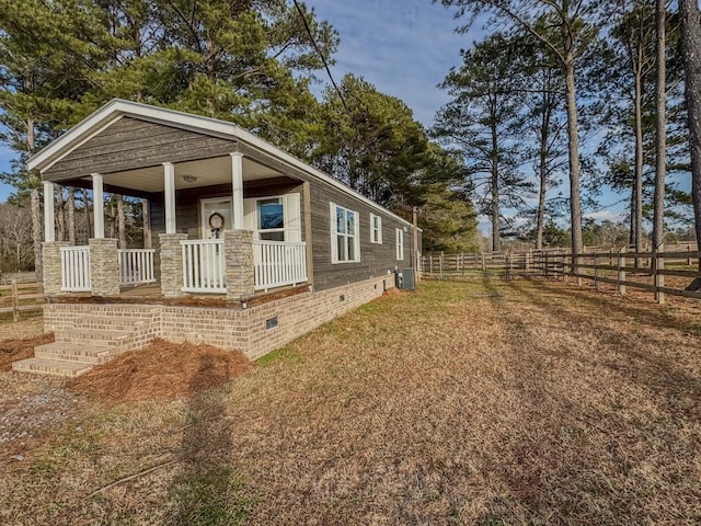 view of side of home featuring central AC unit and covered porch