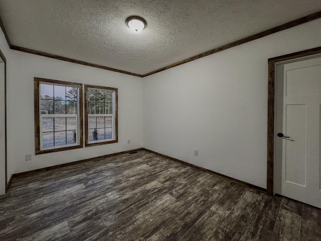 empty room with crown molding, dark wood-type flooring, and a textured ceiling