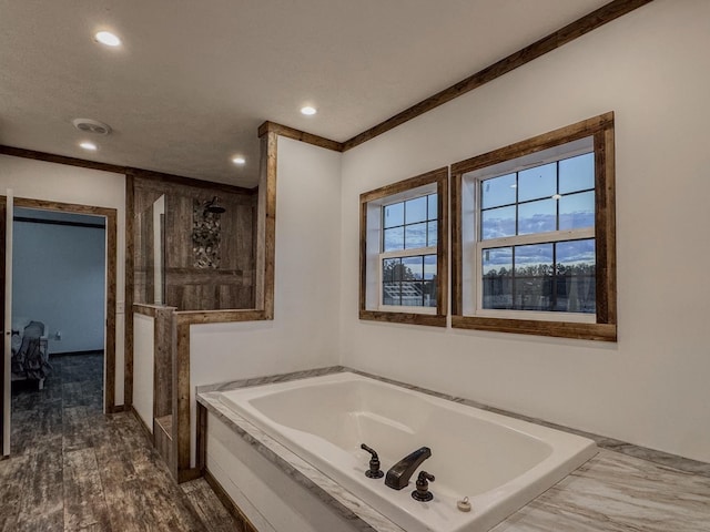 bathroom featuring wood-type flooring and tiled tub