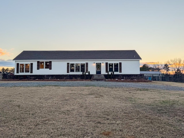 ranch-style home with a lawn