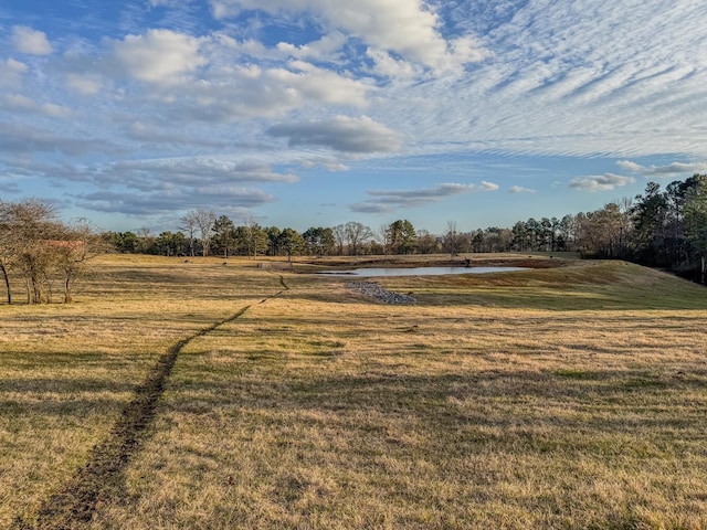 view of yard featuring a water view and a rural view