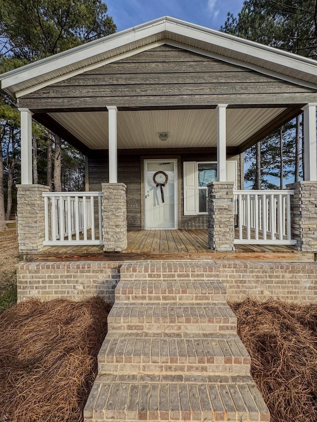 view of exterior entry with a porch