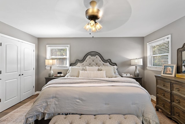 bedroom featuring ceiling fan, a closet, and hardwood / wood-style floors