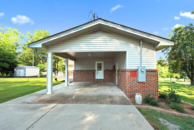 exterior space with a yard, a shed, and a carport