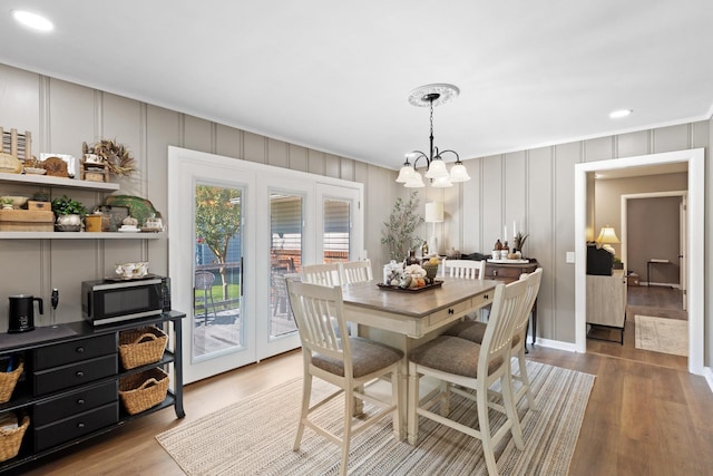 dining area with a notable chandelier, light hardwood / wood-style floors, and a wealth of natural light