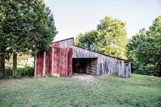 view of outdoor structure featuring a lawn