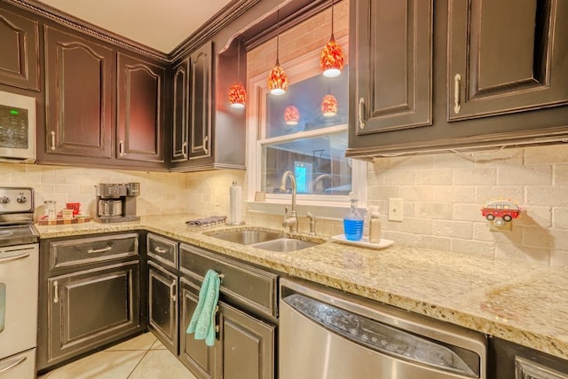 kitchen featuring dark brown cabinetry, sink, white appliances, decorative backsplash, and light tile patterned flooring