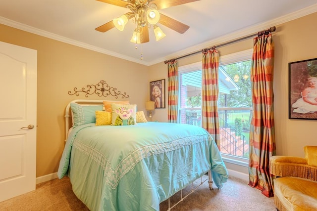 carpeted bedroom featuring ceiling fan and crown molding