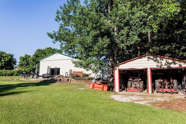 view of yard featuring an outbuilding and a garage