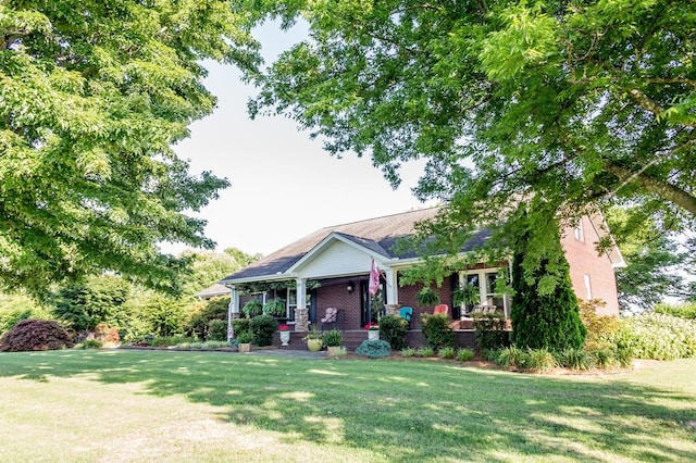 view of front of property with a porch and a front yard