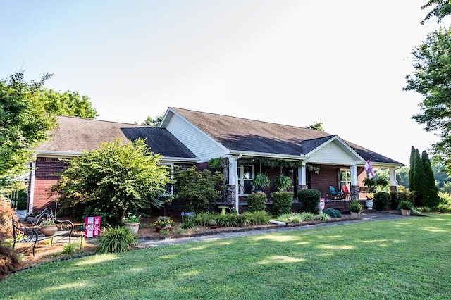 view of front of home with covered porch and a front yard