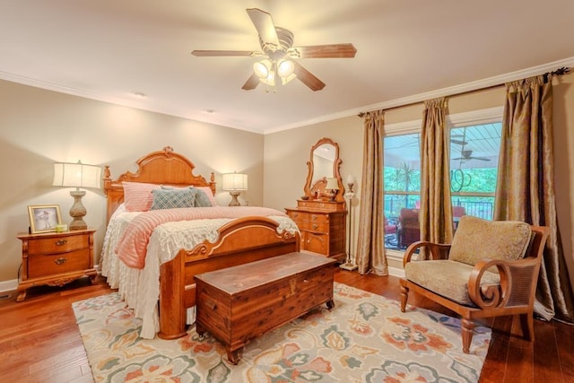 bedroom with hardwood / wood-style flooring, ceiling fan, and ornamental molding