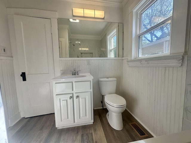 bathroom with vanity, crown molding, toilet, walk in shower, and wood-type flooring